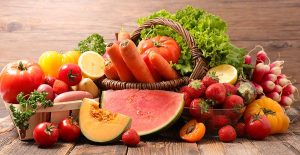 Display of Fruits and Vegetables Filling and Surrounding a Basket - Mary's Harvest Products